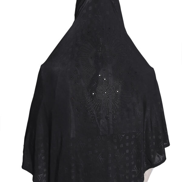 A woman modeling a Black Patterned Embellished Hijab, viewed from the side, highlighting the subtle square pattern and the rhinestone embellishment on the cap area.