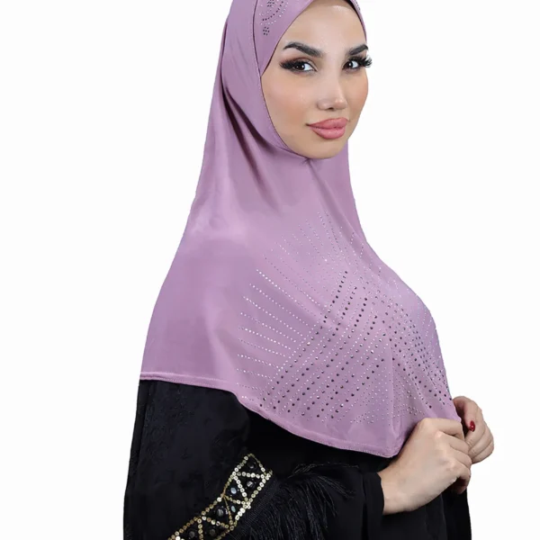 A woman models a stunning Light Purple Rhinestone Hijab, viewed from the side, showcasing the sparkling sunburst design on the fabric and the embellished cap area.