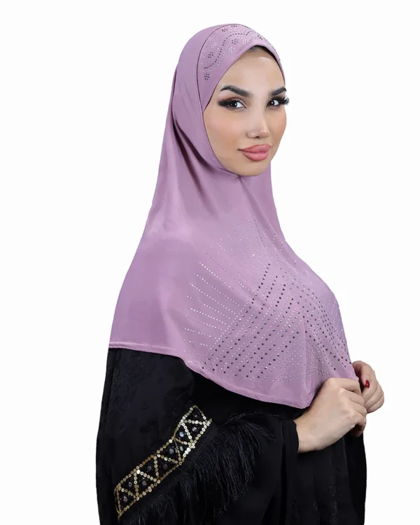 A woman models a stunning Light Purple Rhinestone Hijab, viewed from the side, showcasing the sparkling sunburst design on the fabric and the embellished cap area.
