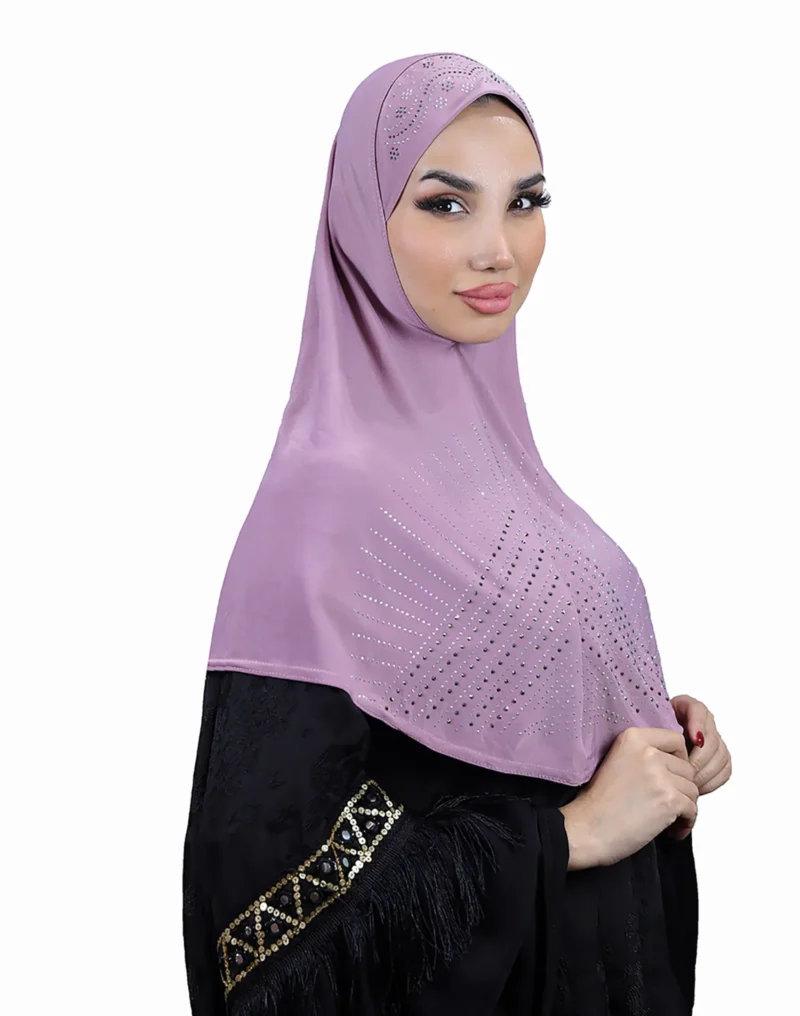 A woman models a stunning Light Purple Rhinestone Hijab, viewed from the side, showcasing the sparkling sunburst design on the fabric and the embellished cap area.
