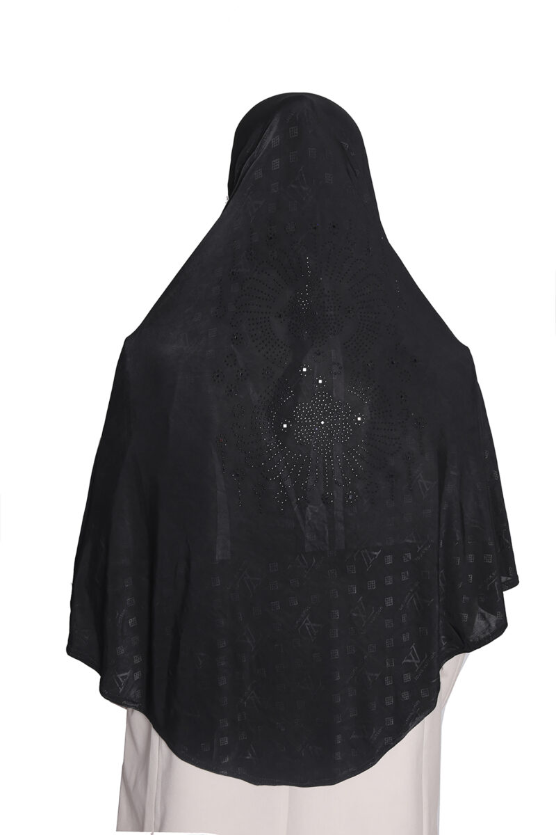 A woman modeling a Black Patterned Embellished Hijab, viewed from the side, highlighting the subtle square pattern and the rhinestone embellishment on the cap area.