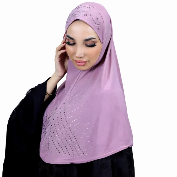 A woman models a Light Purple Rhinestone Hijab, looking down gently, highlighting the rhinestone pattern and the soft drape of the material.