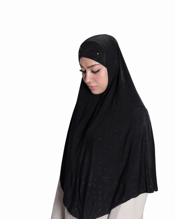 The back view of a Black Patterned Embellished Hijab showcasing a central rhinestone sunburst design and subtle all-over geometric pattern on the flowing fabric.
