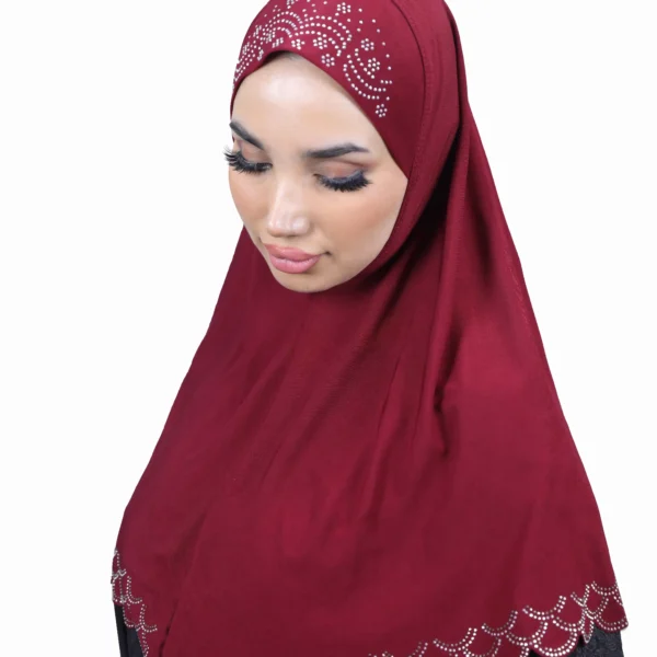 A woman modeling the Maroon Embroidered Hijab with Beadwork, posing with hands folded, showcasing the rhinestone cap design and the matching scalloped trim.