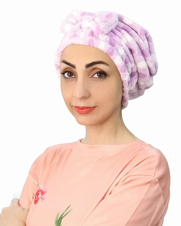 A woman models a Plush Comfort Fashion Turban in a deep color, showing the stylish criss-cross pleating detail at the front.