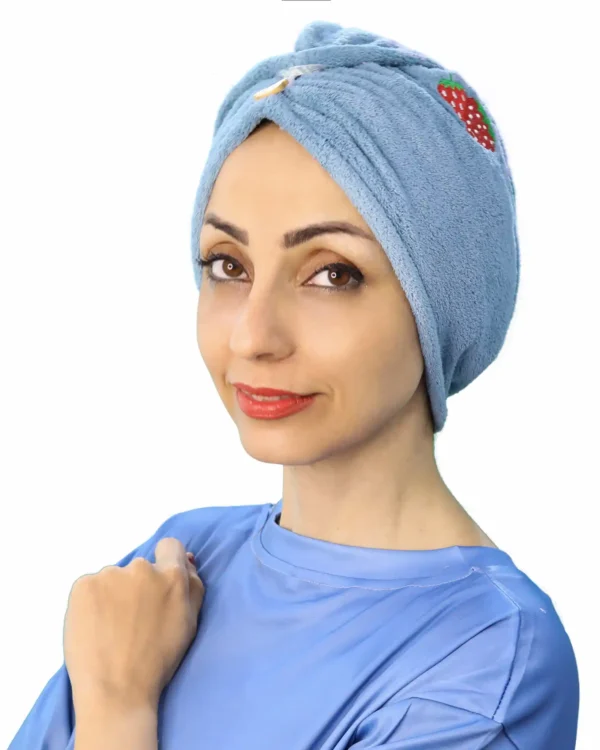 A woman models a Comfortable Embroidered Fashion Turban in a dark blue or black shade, showcasing the ready-to-wear design with a prominent, decorative embroidered patch at the front.