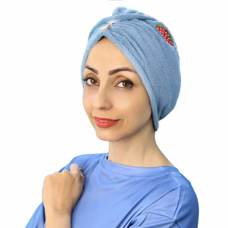 A woman models a Comfortable Embroidered Fashion Turban in a dark blue or black shade, showcasing the ready-to-wear design with a prominent, decorative embroidered patch at the front.
