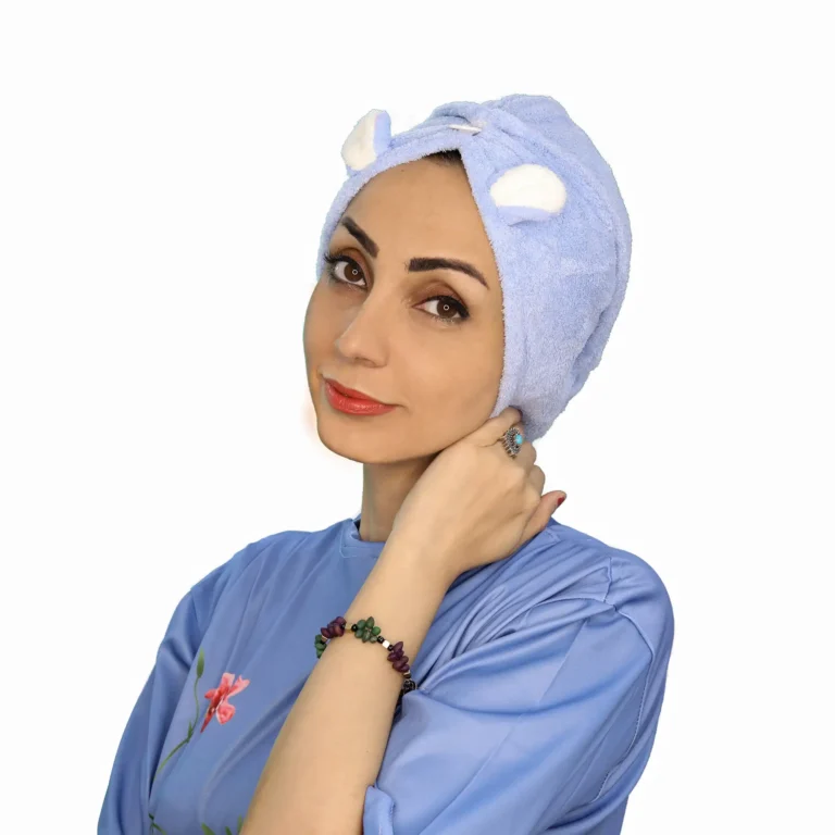 A woman models a fluffy Plush Cute Ear Turban Wrap in a light color, featuring playful rounded ears sewn on top and a gathered front detail.