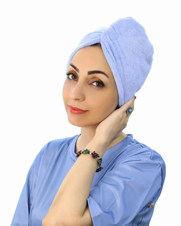 A woman models a pink Soft Microfiber Hair Drying Turban, showing the twist design on top and the button/loop closure at the back.