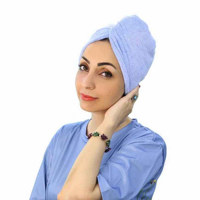 A woman models a pink Soft Microfiber Hair Drying Turban, showing the twist design on top and the button/loop closure at the back.