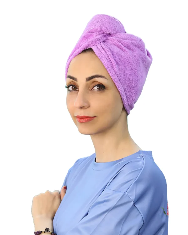 A detail shot of a woman with the Soft Microfiber Hair Drying Turban on, demonstrating the secure loop being attached to the button at the nape of the neck.