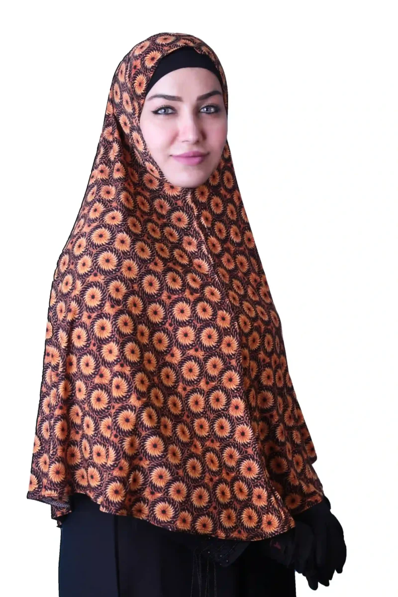 A woman models a Black & Orange Sunburst Rayon Hijab, looking straight at the camera with her hands clasped, emphasizing the full coverage and comfortable fit.