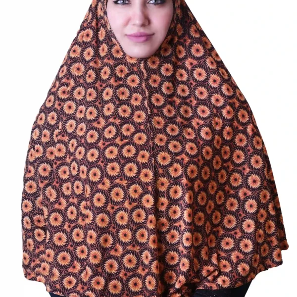 A woman models a stylish Black & Orange Sunburst Rayon Hijab, showing off the unique sunburst pattern and how the hijab drapes elegantly over her shoulder.