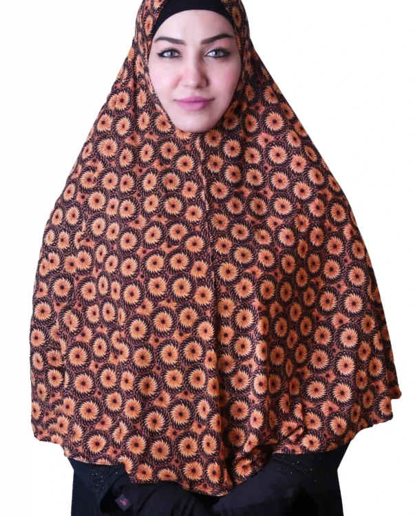 A woman models a stylish Black & Orange Sunburst Rayon Hijab, showing off the unique sunburst pattern and how the hijab drapes elegantly over her shoulder.