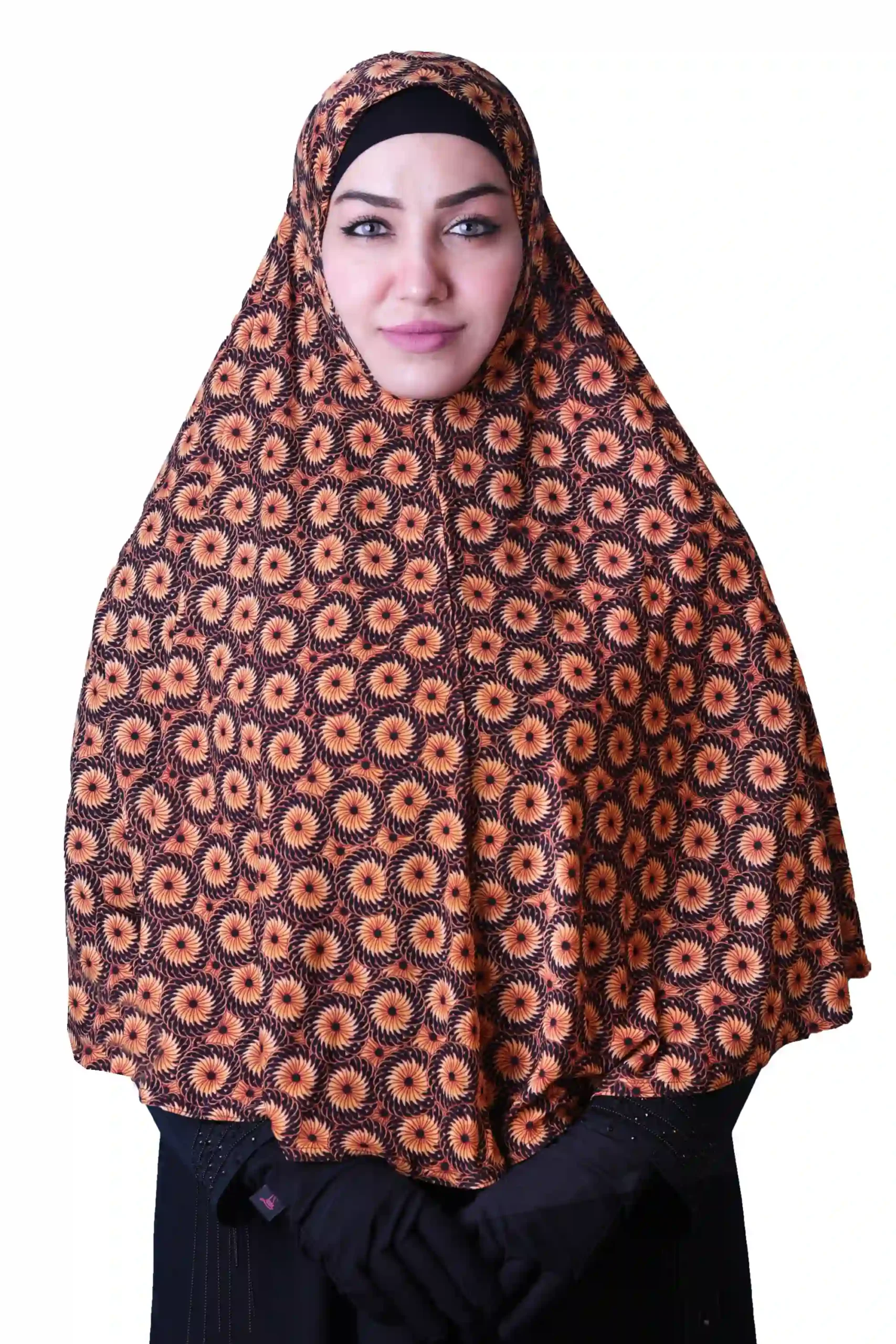 A woman models a stylish Black & Orange Sunburst Rayon Hijab, showing off the unique sunburst pattern and how the hijab drapes elegantly over her shoulder.