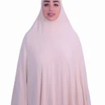 A woman modeling a luxurious fawn beige cotton hijab, viewed from the side, showcasing the elegant drape of the fabric. Luxury Cotton Hijab in Fawn Beige