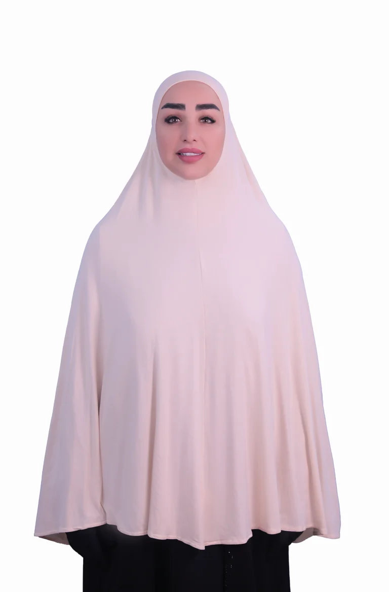 A woman modeling a luxurious fawn beige cotton hijab, viewed from the side, showcasing the elegant drape of the fabric. Luxury Cotton Hijab in Fawn Beige