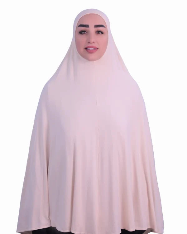 A woman modeling a luxurious fawn beige cotton hijab, viewed from the side, showcasing the elegant drape of the fabric. Luxury Cotton Hijab in Fawn Beige