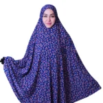 A woman modeling a Premium Blue Floral Rayon Ladies Hijab, standing from the side to show off its beautiful design and drape.
