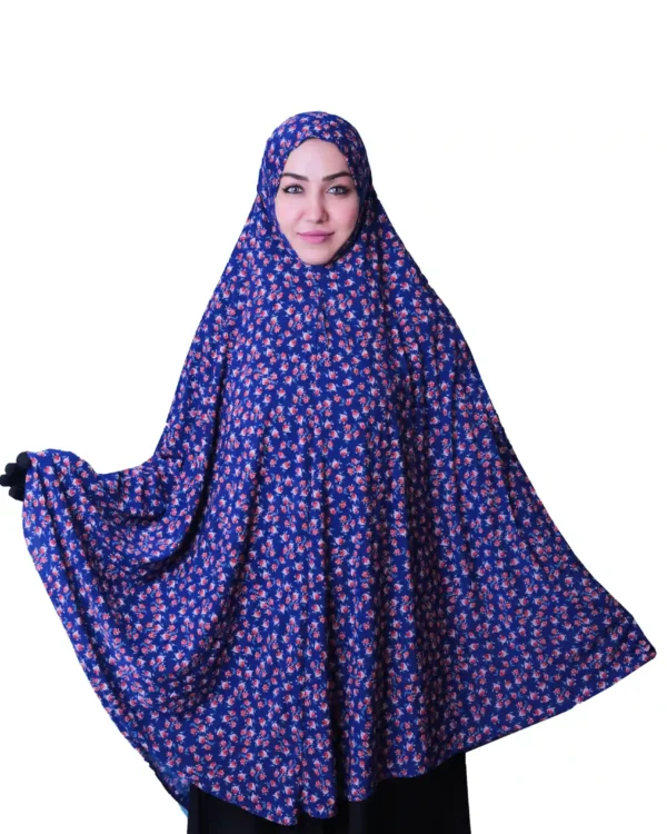 A woman modeling a Premium Blue Floral Rayon Ladies Hijab, standing from the side to show off its beautiful design and drape.