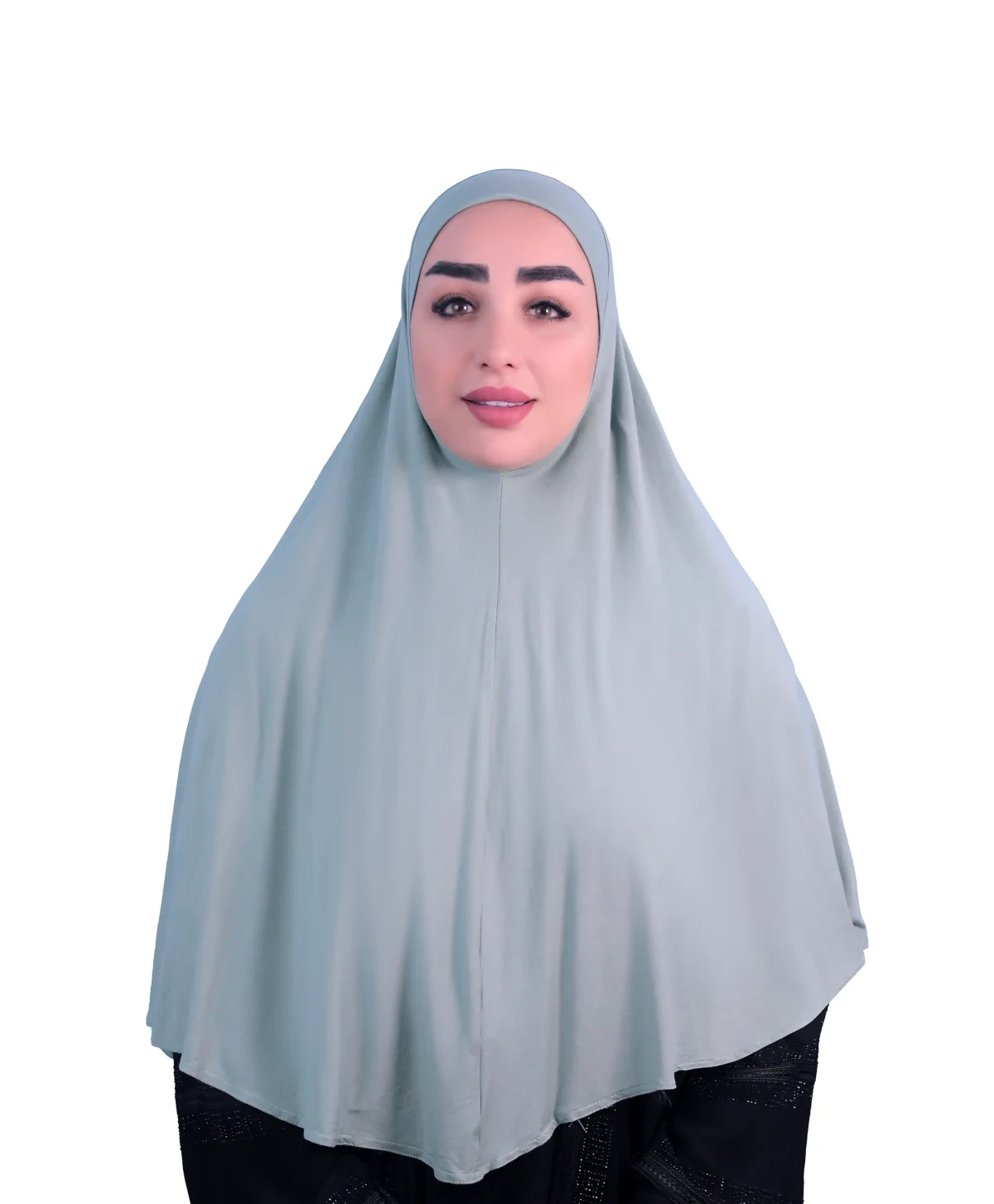 A woman models a Sage Green Cotton Hijab for Women, facing forward with a gentle smile, emphasizing the comfortable fit and simple, elegant style of the hijab.