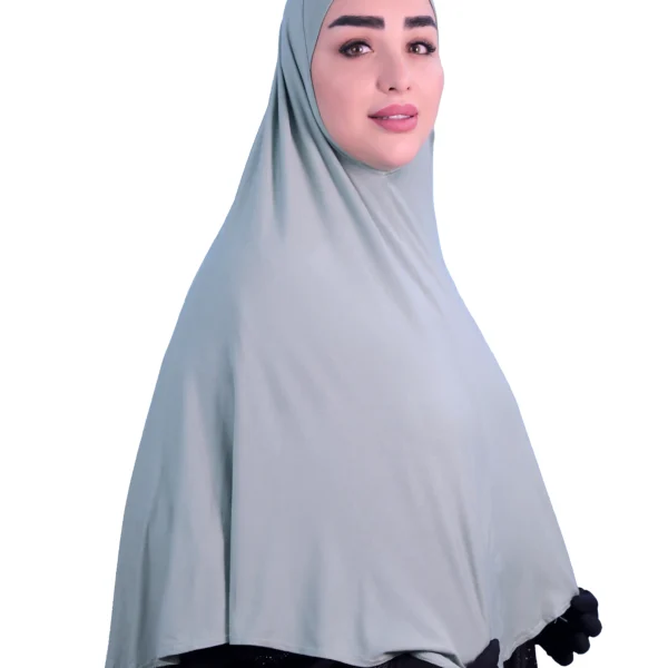 A woman models a Sage Green Cotton Hijab for Women, shown from the back to highlight the graceful flow of the fabric and the full-coverage design.