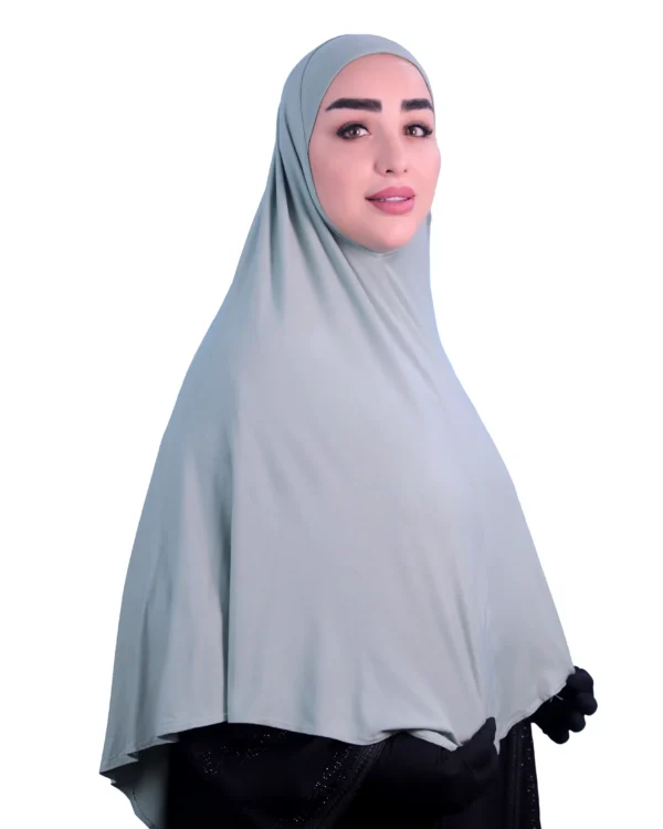A woman models a Sage Green Cotton Hijab for Women, shown from the back to highlight the graceful flow of the fabric and the full-coverage design.