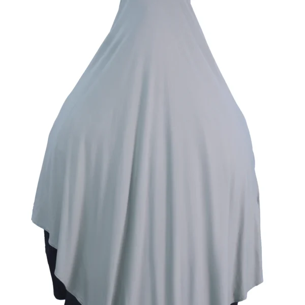 A woman models a Sage Green Cotton Hijab for Women, posing from the side to showcase the soft, lightweight material and elegant drape.