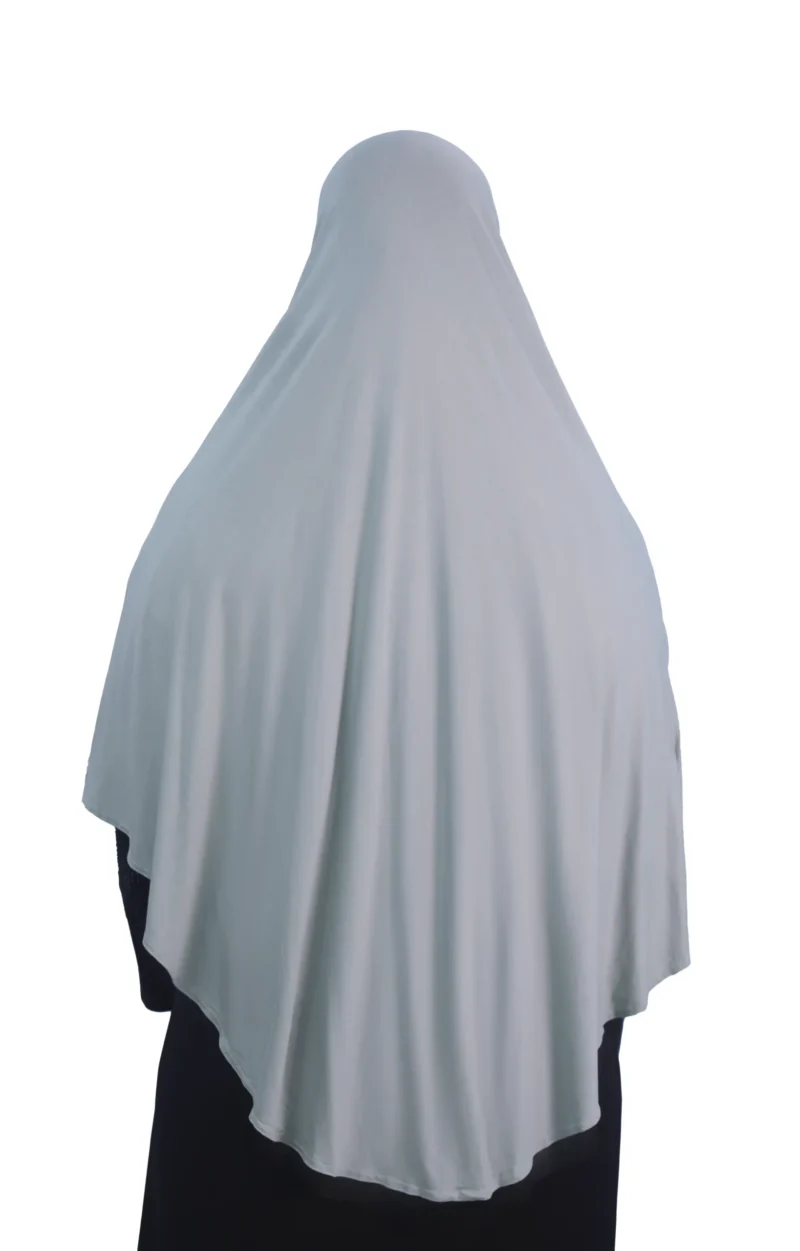 A woman models a Sage Green Cotton Hijab for Women, posing from the side to showcase the soft, lightweight material and elegant drape.