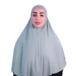 A woman models a Sage Green Cotton Hijab for Women, facing forward with a gentle smile, emphasizing the comfortable fit and simple, elegant style of the hijab.
