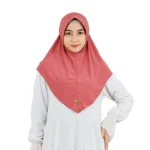 A woman models a Dusty Rose Chevron Hijab, posing at an angle to showcase the texture, the elegant drape, and the decorative braid detail at the top.