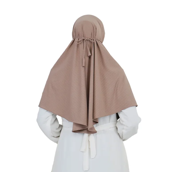 A woman models a Light Brown Striped Texture Hijab for Women, facing forward with one hand near her neck, highlighting the textured material and modest, ready-to-wear design.