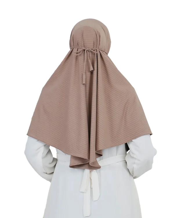 A woman models a Light Brown Striped Texture Hijab for Women, facing forward with one hand near her neck, highlighting the textured material and modest, ready-to-wear design.