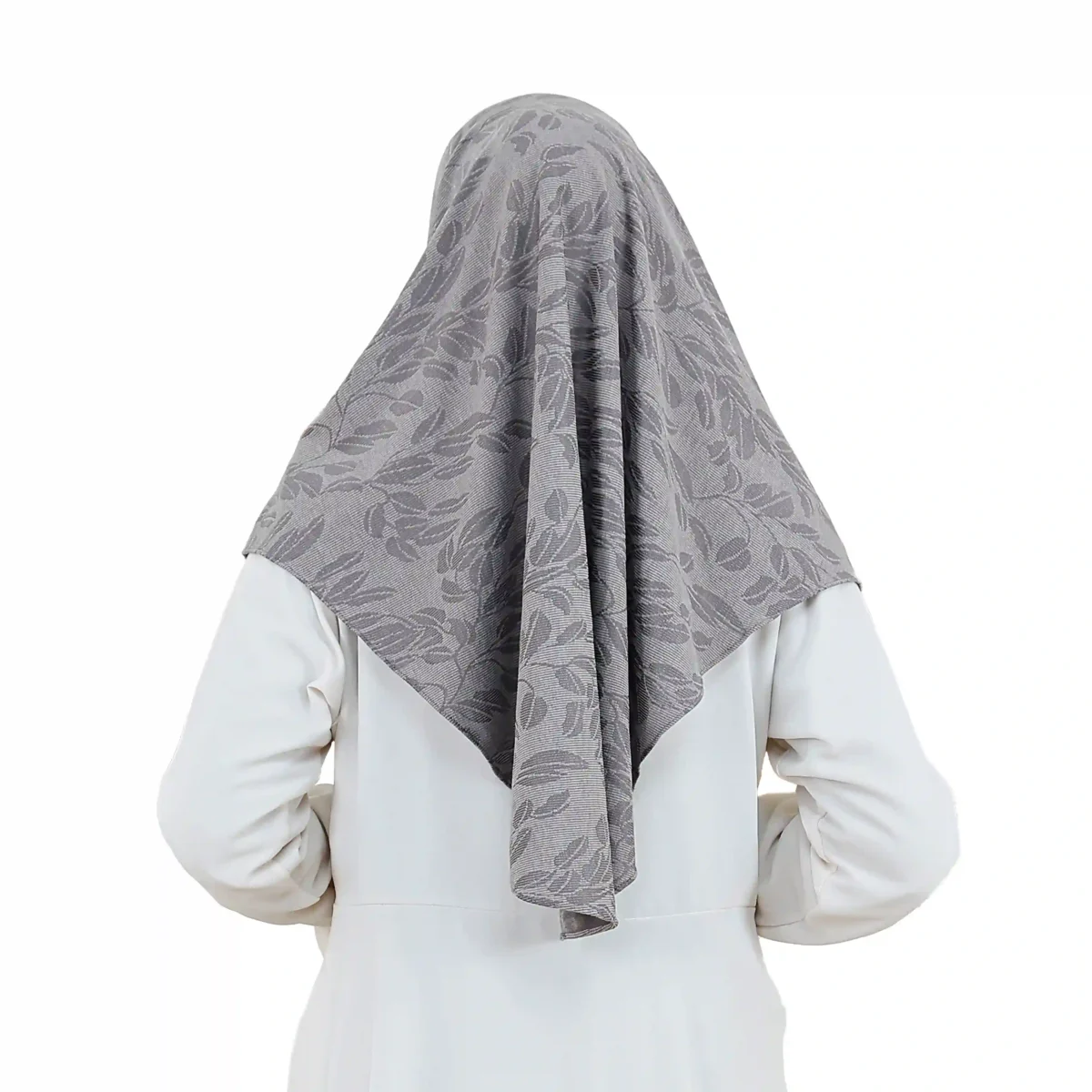 A woman models a Chic Grey Hijab with Leaf Pattern, facing forward and smiling slightly, highlighting the ready-to-wear style and the elegant tone-on-tone leaf motif.