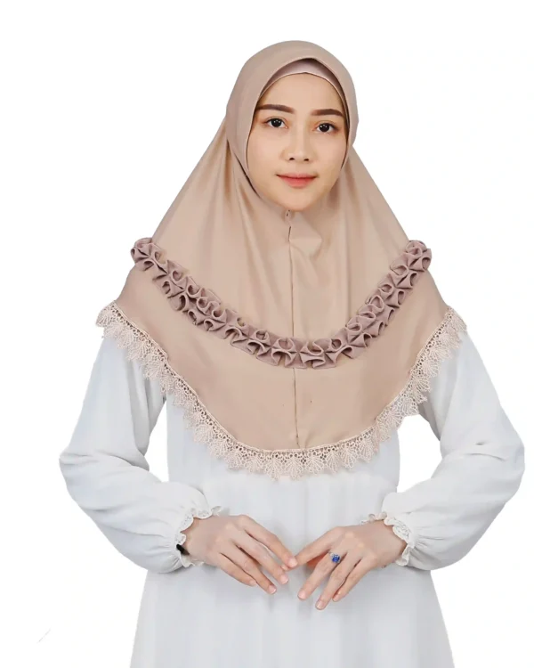 A woman models an Elegant Beige Ruffled and Lace Hijab, facing forward to showcase the beautiful scalloped lace trim and the decorative, voluminous ruffles across the chest.