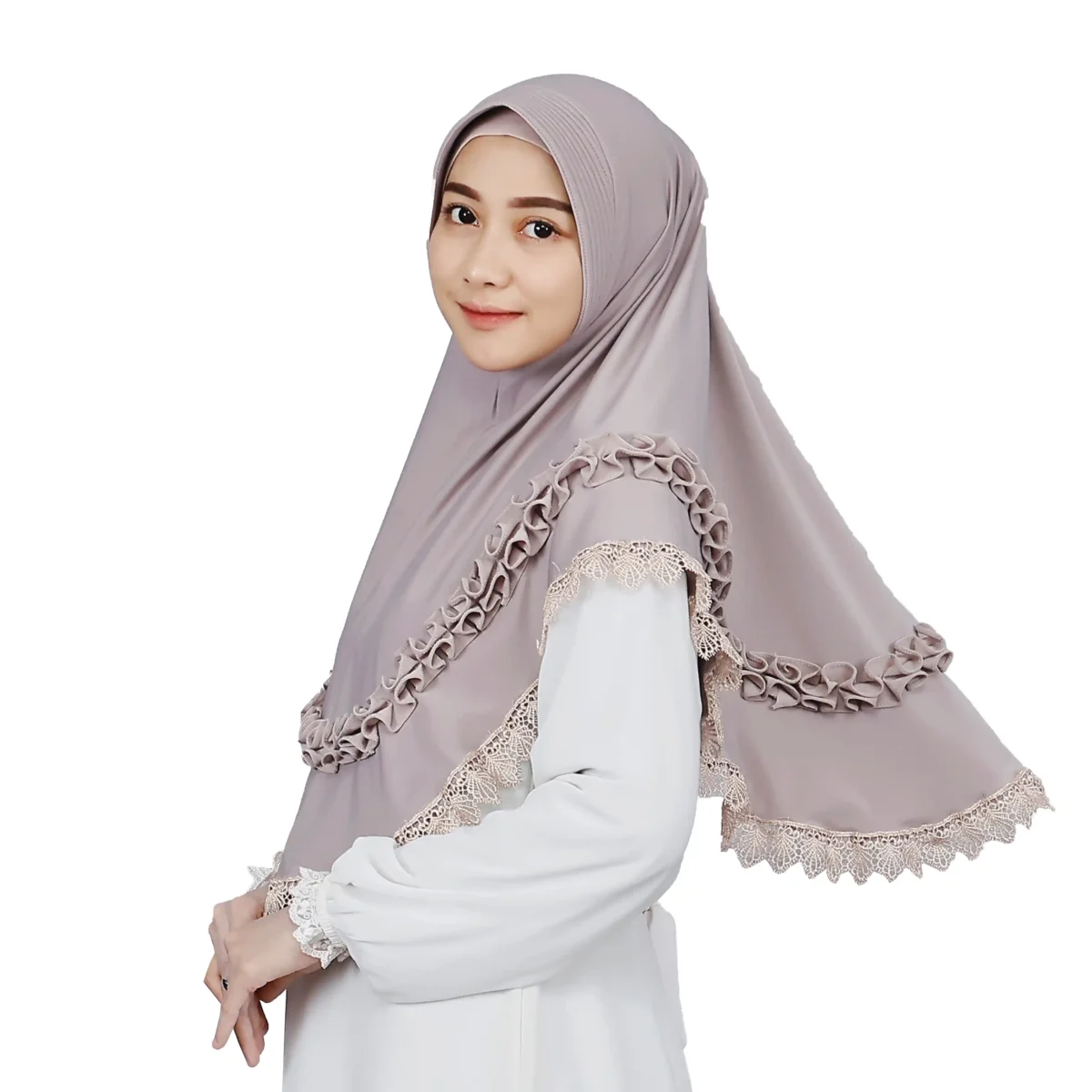 A woman models a Mauve Grey Ruffled and Lace Hijab, viewed from the side, emphasizing the soft fabric, the comfortable fit, and the stylish ruffles and lace trim.