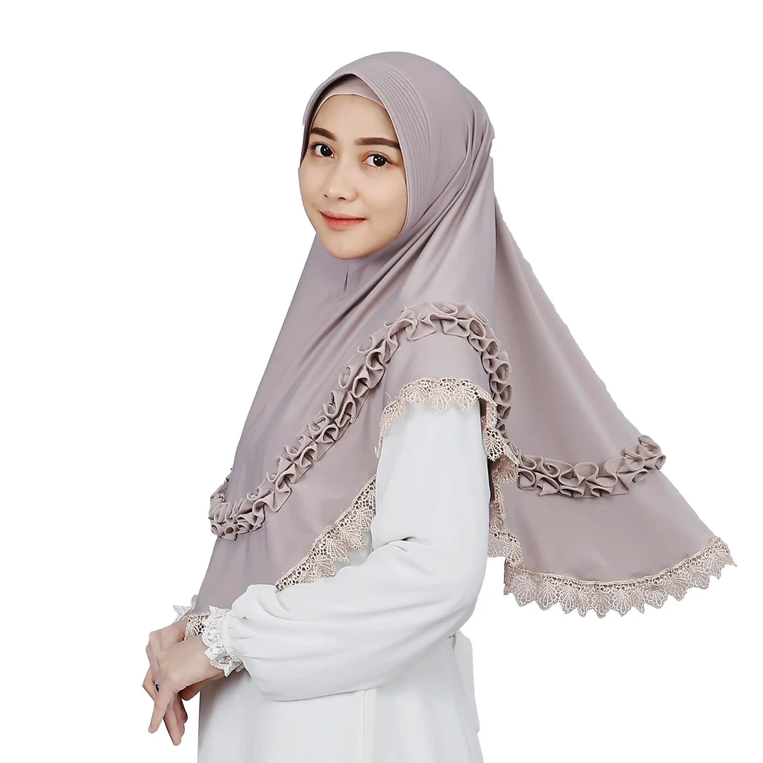 A woman models a Mauve Grey Ruffled and Lace Hijab, viewed from the side, emphasizing the soft fabric, the comfortable fit, and the stylish ruffles and lace trim.