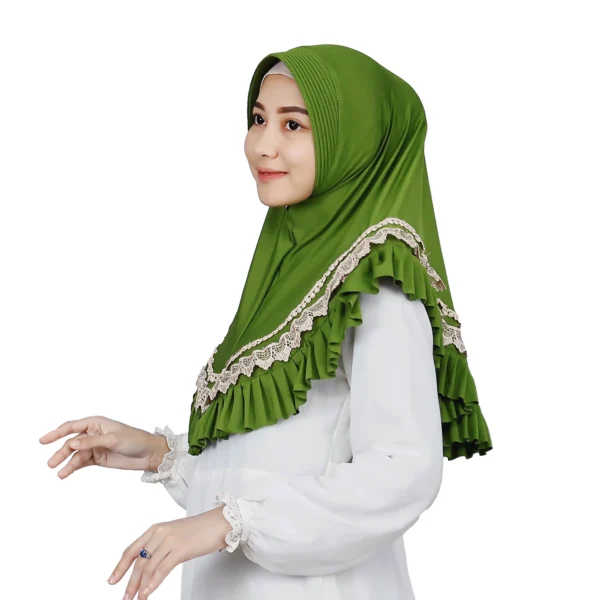 A woman models a Vibrant Green Ruffled and Lace Hijab, facing forward with one hand near her head, showcasing the contrasting lace and the dramatic ruffle detail across the chest.